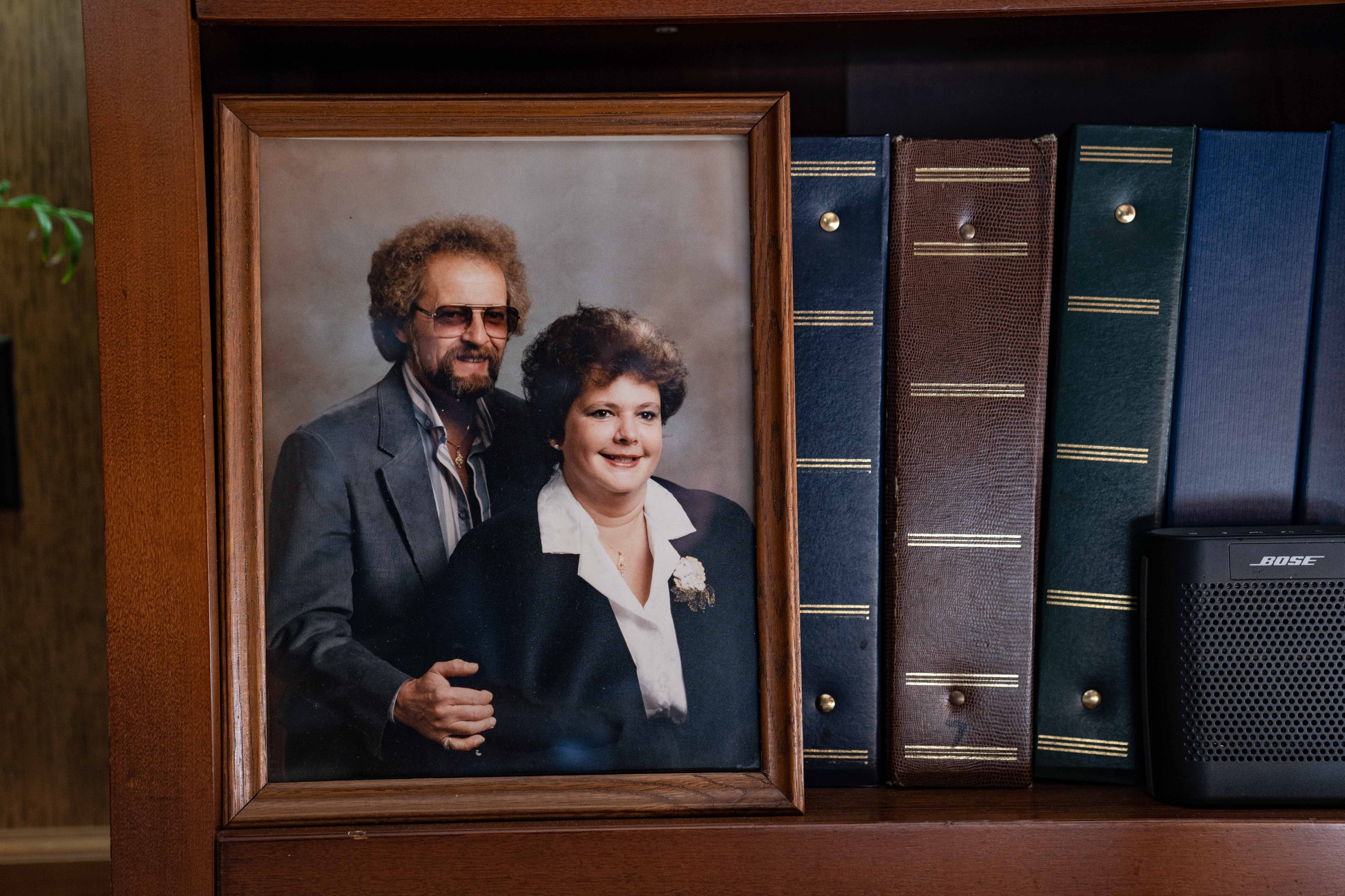 A photograph of Charles and Sue Miller, parents of Shana Driver, sit on a shelf of albums in her kitchen in Kokomo, Indiana. Sue Miller died at Waterford Place Health Campus in Kokomo, Indiana.