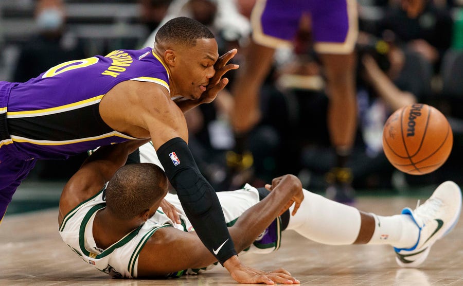 Nov. 17: Lakers guard Russell Westbrook gets a face full of Bucks forward Khris Middleton's hand while they scramble for a loose ball in Milwaukee.