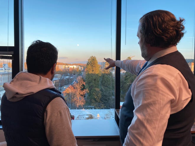 Local lawyer and veteran Bryan Boender and his friend Yasin look out over Eugene at Boender's office. Yasin and his family have lived in Eugene for about a month after narrowly escaping Afghanistan.