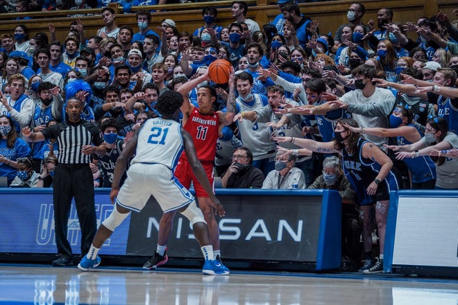 Gardner-Webb's Leon Williams is harassed by the "Cameron Crazies" during Tuesday's game at Duke's Cameron Indoor Stadium in Durham.