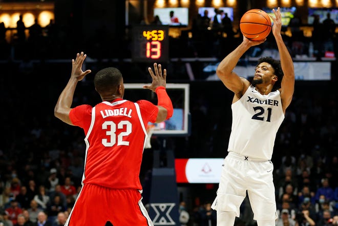 Xavier Musketeers forward Jerome Hunter (21) shoots from three point range in the first half of the NCAA basketball game between the Xavier Musketeers and the Ohio State Buckeyes at the Cintas Center in Cincinnati on Thursday, Nov. 18, 2021.