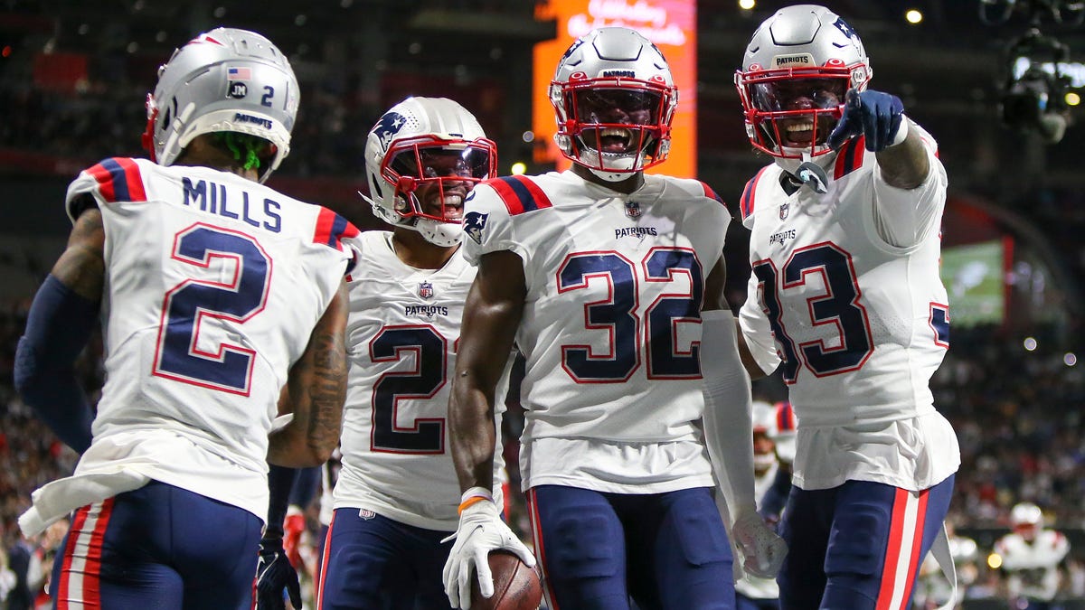 New England Patriots safety Devin McCourty celebrates with teammates after pulling in an interception against the Atlanta Falcons.