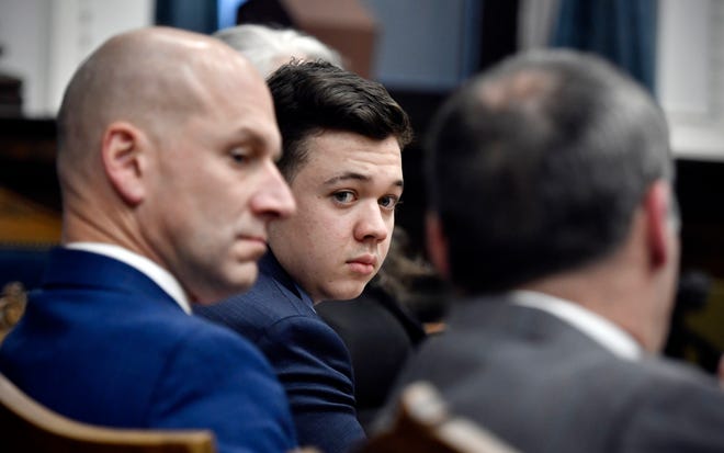Kyle Rittenhouse, center, looks to his attorneys as the jury is fired during his hearing at Kenosha District Court in Kenosha, Wis., on Thursday, Nov. 18, 2021 .