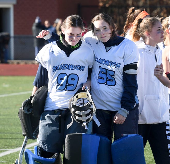 Starting Sandwich goalie Sarah Currey (99) is consoled by goalie Ava Murray after losing to Watertown 1-0 in overtime on Saturday in the MIAA Div. 3 field hockey final.