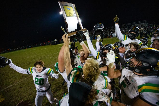 Northridge players celebrate with the trophy after winning the New Prairie vs. Northridge 4A semistate championship game Friday, Nov. 19, 2021at New Prairie High School. 