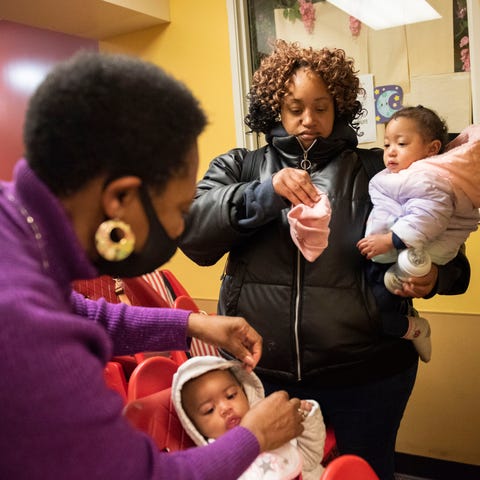 Starla Owens, center, picks up her daughter Cheris