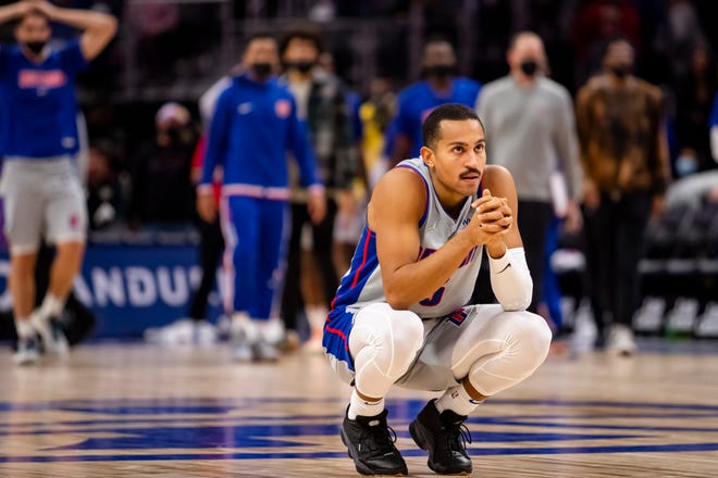 Detroit Pistons guard Frank Jackson (5) crouches down after his game-tying shot at the end of the fourth quarter against the Golden State Warriors rattled out at Little Caesars Arena.
