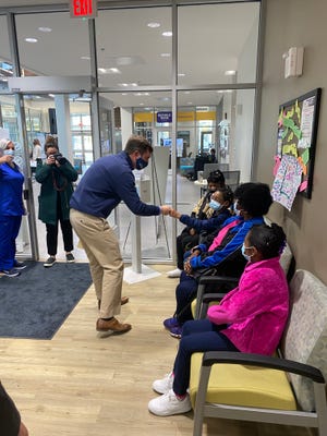 Gov. Andy Beshear greets kids who are about to receive their first COVID-19 vaccine at the Norton Healthcare clinic in the Republic Bank Foundation YMCA of west Louisville