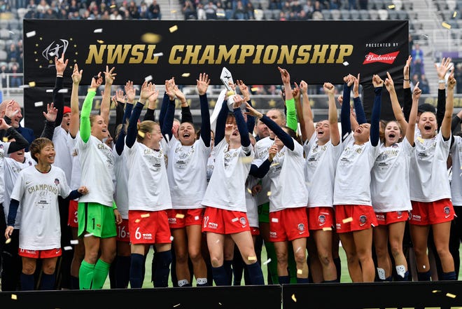 Washington Spirit players and coaches celebrate winning the 2021 NWSL Championship match against the Chicago Red Stars on Nov. 20.