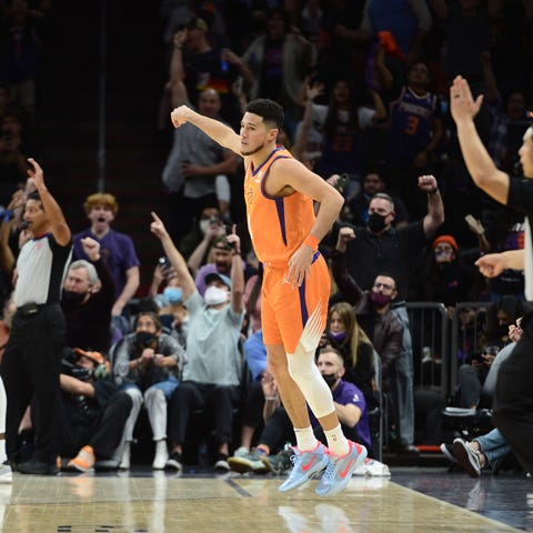 Phoenix Suns guard Devin Booker reacts after makin
