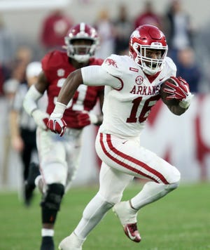 Arkansas wide receiver Treylon Burks (16) runs for a touchdown after making a catch against Alabama last Saturday at Bryant-Denny Stadium in Tuscaloosa, Ala.