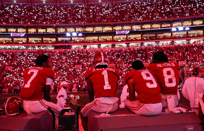 Nov 20, 2021; Tuscaloosa, Alabama, USA;  Alabama wide receiver Ja'Corey Brooks (7), Alabama wide receiver Jameson Williams (1), Alabama quarterback Bryce Young (9) and Alabama wide receiver John Metchie III (8) watche as the lights go red and fans use their cell phones at Bryant-Denny Stadium. Alabama defeated Arkansas 42-35. Mandatory Credit: Gary Cosby Jr.-USA TODAY Sports