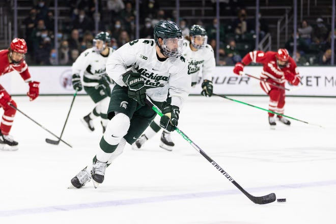 MSU senior defenseman Cole Krygier skates with the puck in the first period of Saturday's 5-2 victory over Wisconsin. Krygier recorded two assists on the night.