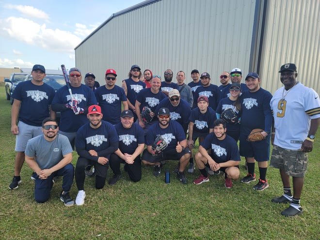 The Ascension Parish Council's Alvin "Coach" Thomas takes a group photo with participants in the adult softball league.
