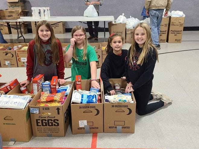 Helping to pack the Bedford Goodfellows’ food boxes were members of Bedford Girls 12U and 10U softball teams.