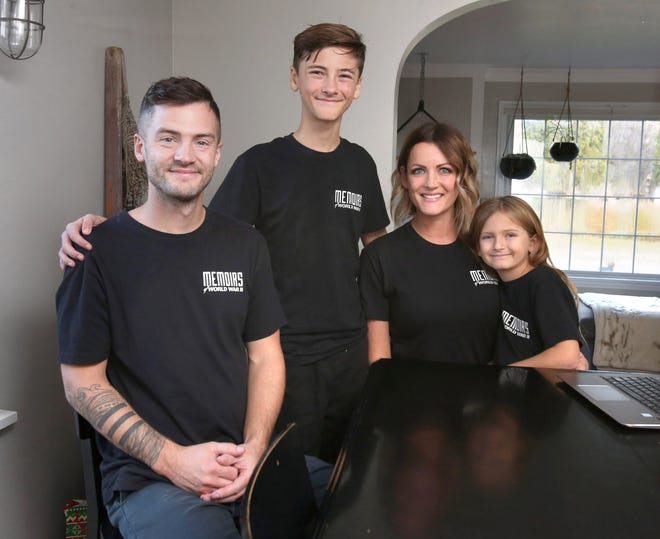 Josh, Logan, Heather and Charli Scott are shown in their home in North Canton on Nov. 22. The family has traveled the country filming World War II veterans and shares the stories on a YouTube channel that has more than 300,000 subscribers.