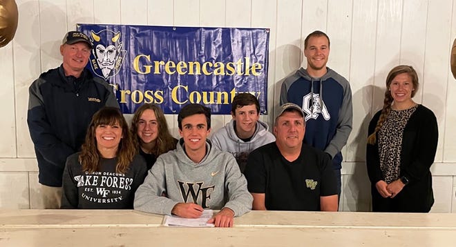 Greencastle-Antrim senior Weber Long signs his National Letter of Intent to run cross country and track at Wake Forest University, joined by, from left, coach Rich Secrest, mother Megan Long, sister Acacia Long, brother Spencer Long, father Mike Long and coaches Kyle Phillips and Nikki Martin.