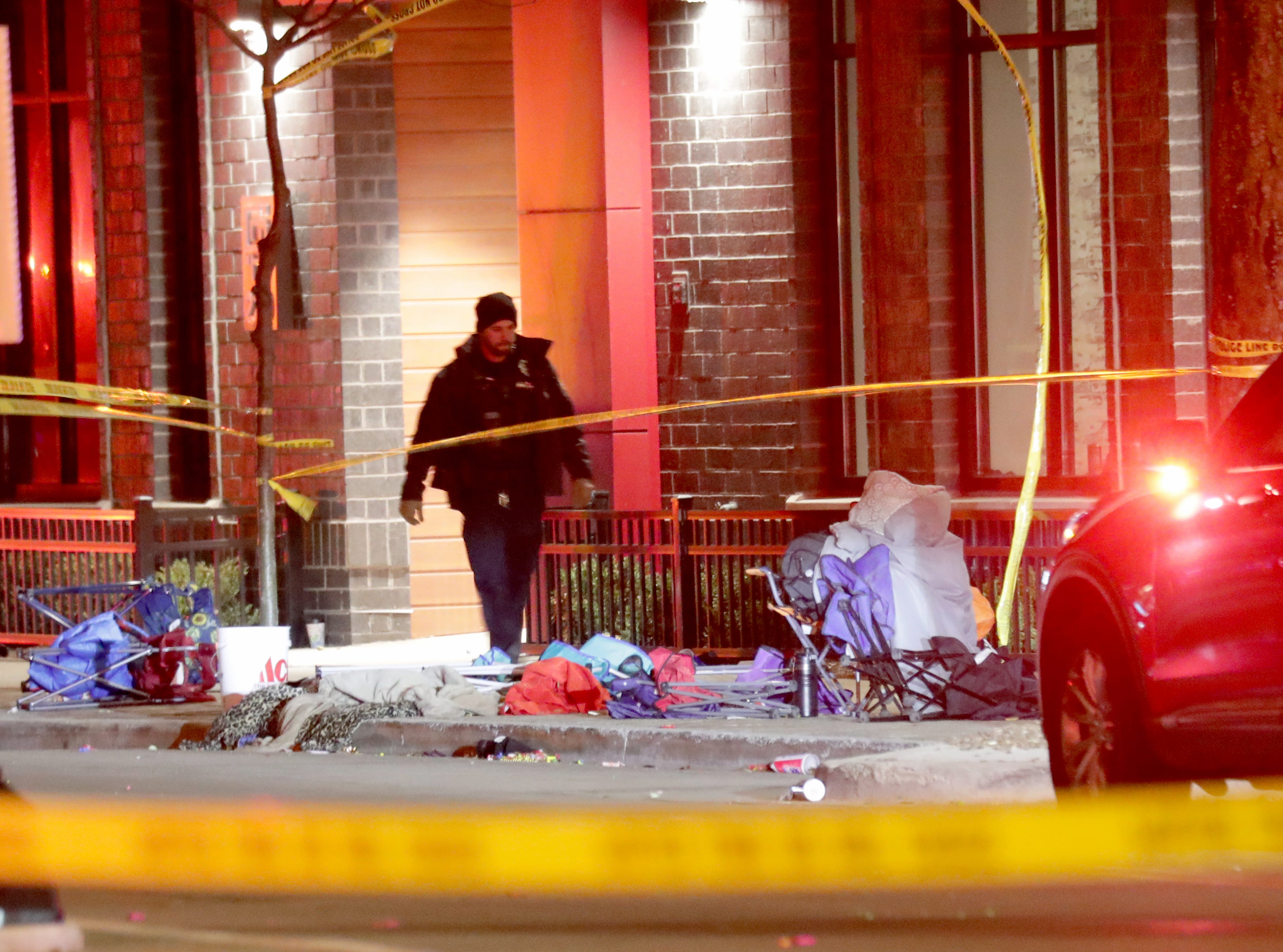 A Waukesha police officer walking the scene.