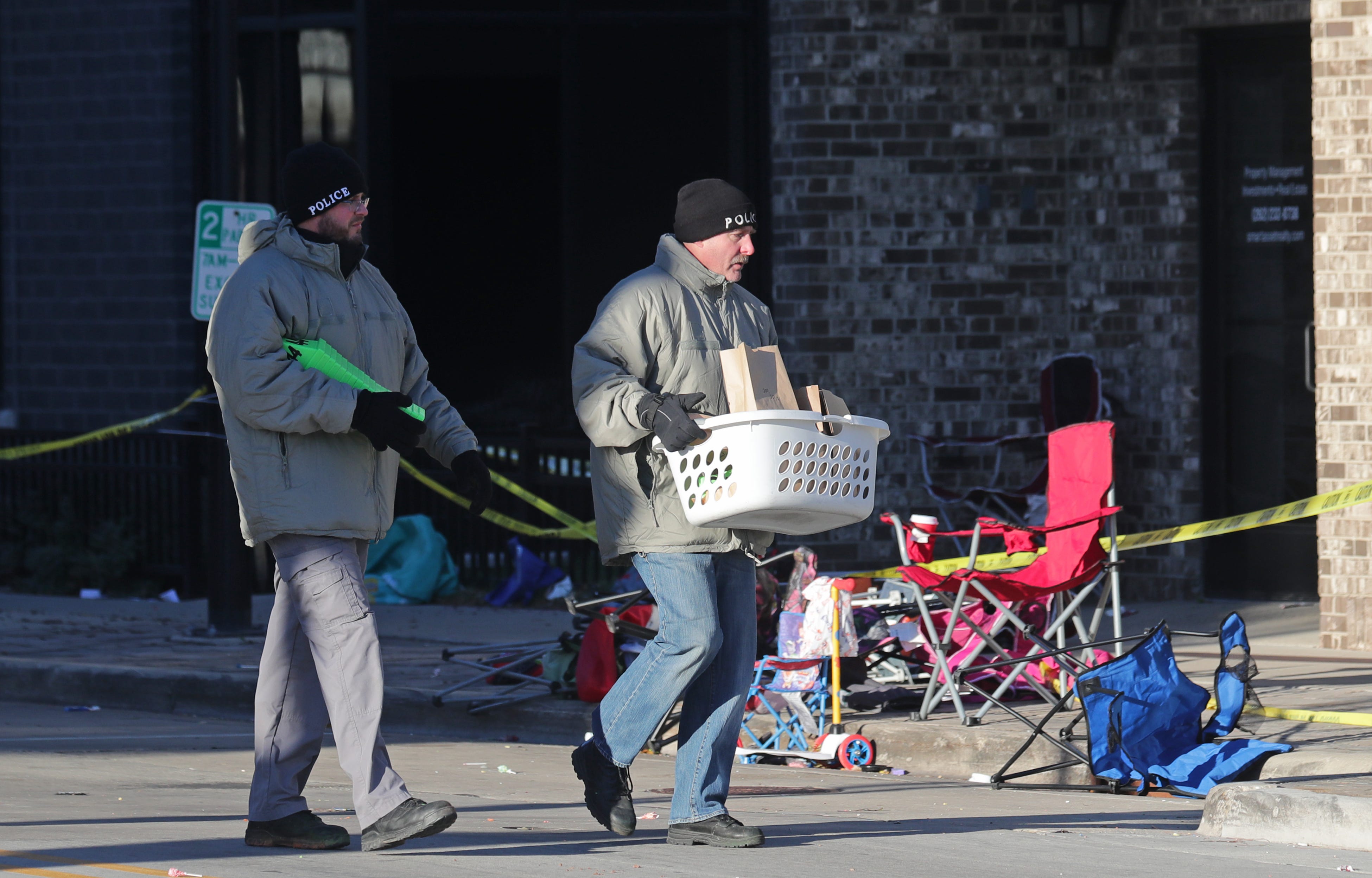 A Waukesha police officer walking the scene.