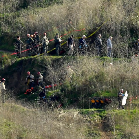 Investigators work the scene of a helicopter crash