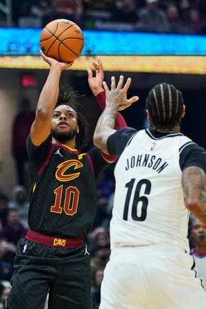 Cavaliers guard Darius Garland (10) shoots over Brooklyn Nets forward James Johnson (16) during the first half of the Nets' 117-112 win Monday night in Cleveland. [Tony Dejak/Associated Press]