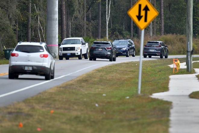 Traffic moves along a two-lane portion of Race Track Road  Friday, November 19, 2021. The city of Jacksonville will be voting at an upcoming meeting on an agreement for spending $10.7 million to widen a portion of Race Track Road from Bartram Park Boulevard to just west of where Race Track Road has an overpass across Interstate 95. [Bob Self/Florida Times-Union]