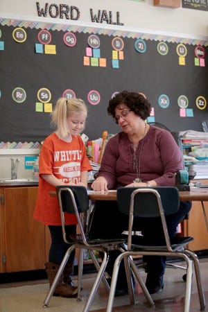 Whittier Elementary School teacher Joyce Spanakis works with Harley Marcurella on a writing assignment in class. The district has plans to replace Whittier, the district's oldest elementary school, as well as Franklin and Gorrell, with two new pre-kindergarten to third grade schools through a partnership with the Ohio Facilities Construction Commission.