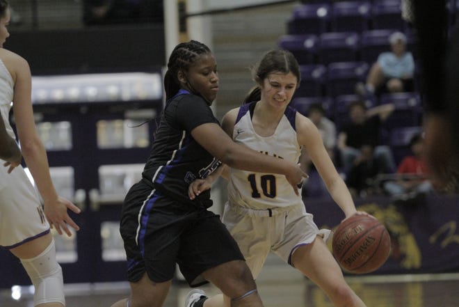 Wylie guard Caroline Steadman dribbles past a defender reaching in the Bulldogs' three-point win over North Crowley.