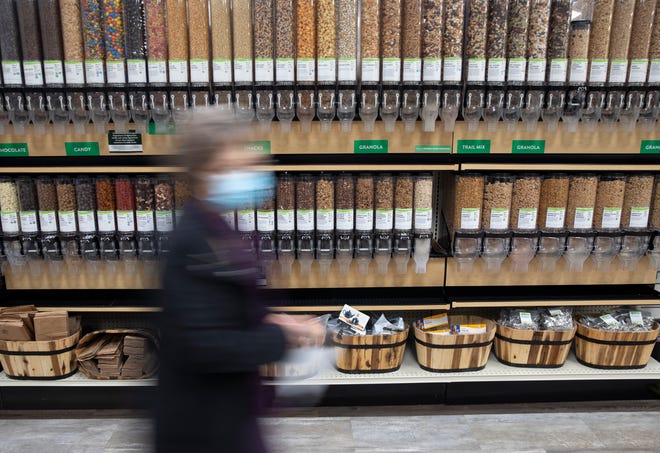 Pennie Myers shops for bulk ingredients at LifeSource Natural Foods in Salem on Tuesday, Nov. 23, 2021.