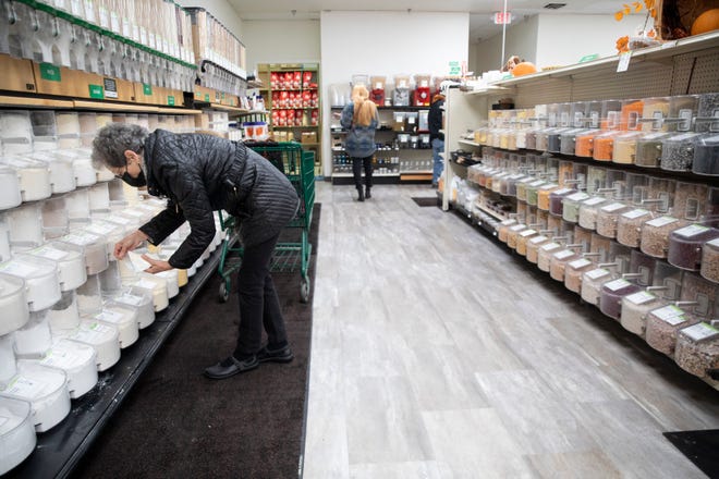 People shop in the bulk section at LifeSource Natural Foods in Salem on Nov. 23, 2021.