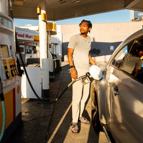 A motorist fills up at a Shell station Nov. 22 in 