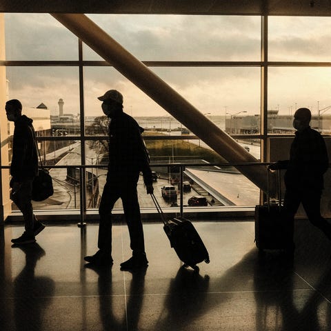 Travelers walk through the Detroit Metropolitan Wa