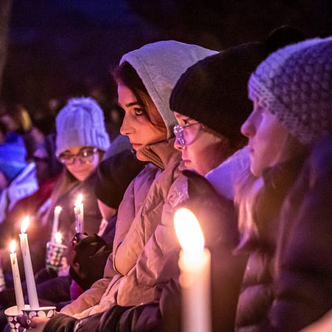 People gather in Cutler Park for a candlelight vig