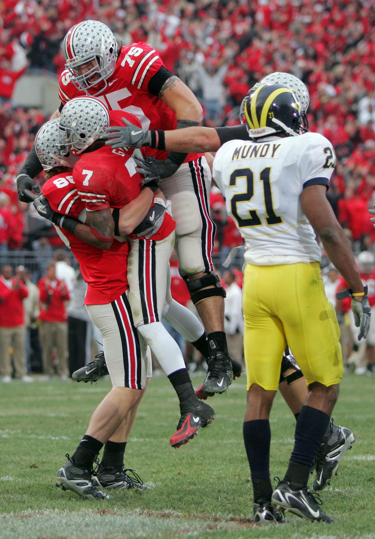 Ohio State's Rory Nicol, 88, lifts Ted Ginn Jr., 7, as Alex Boone, 75, join in to celebrate Ginn's touchdown against Michigan in the first half of their game at the Ohio Stadium, November 18, 2006.  (Dispatch photo by Neal C. Lauron)