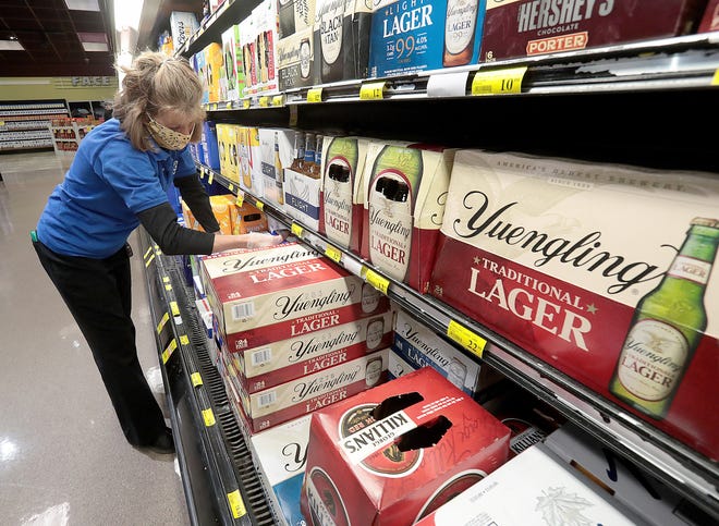 Tammy Kempthorne, a Beer and Wine specialist at ACME Fresh Market in North Canton stocks the shelves at the store.