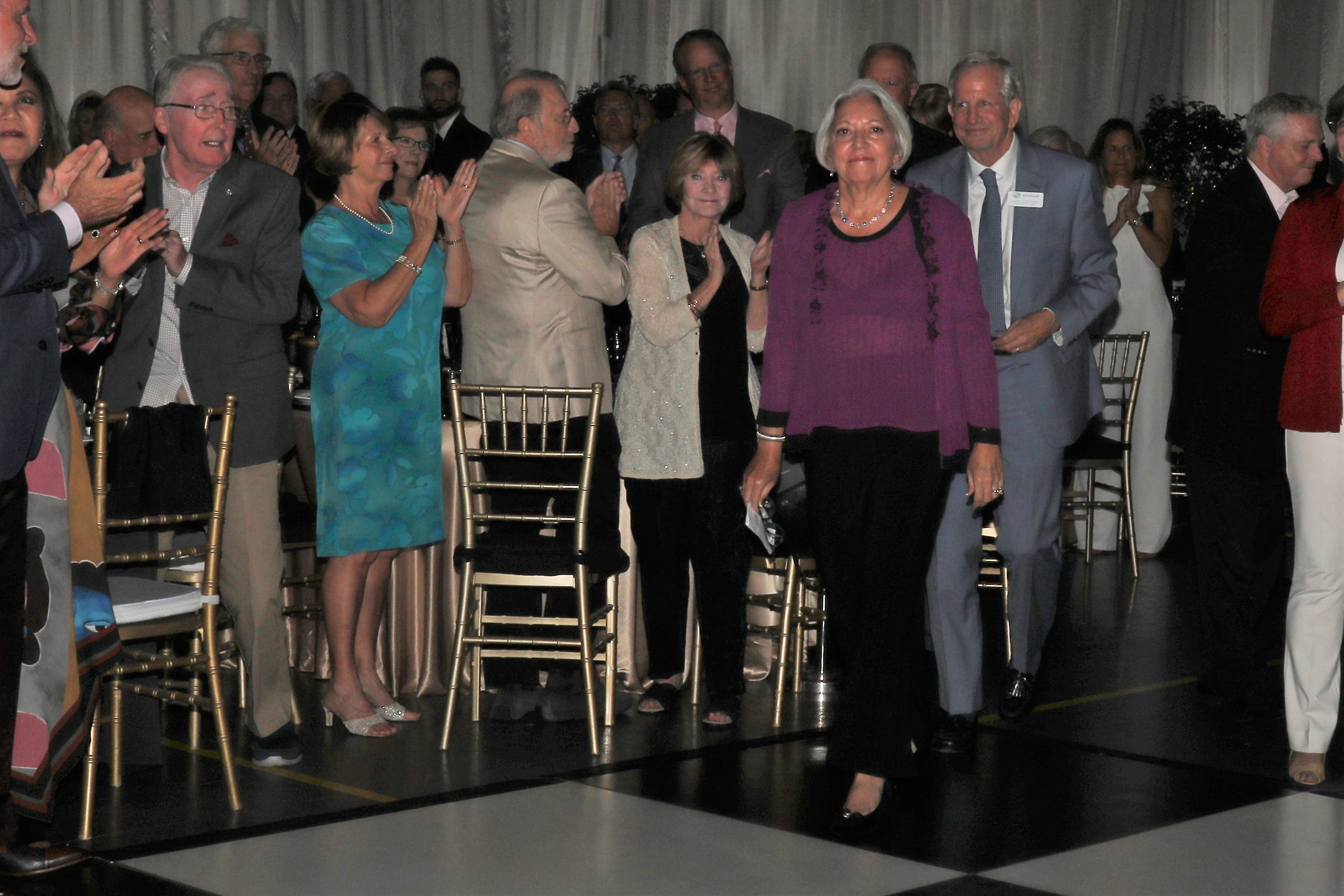 Marjolaine and Steven Townsend make their way to the podium amidst thunderous applause as they accept recognition for their contributions to the Boys and Girls Club. Boys & Girls Clubs of Sarasota and DeSoto Counties held their Champions for Children Gala on November 20, 2021. Over 400 people came out to celebrate longtime supporters and donors Steven and Marjolaine Townsend who also have a scholarship fund in their name that has benefitted thirty-two college students since its inception in 2018. JANET COMBS/HERALD-TRIBUNE