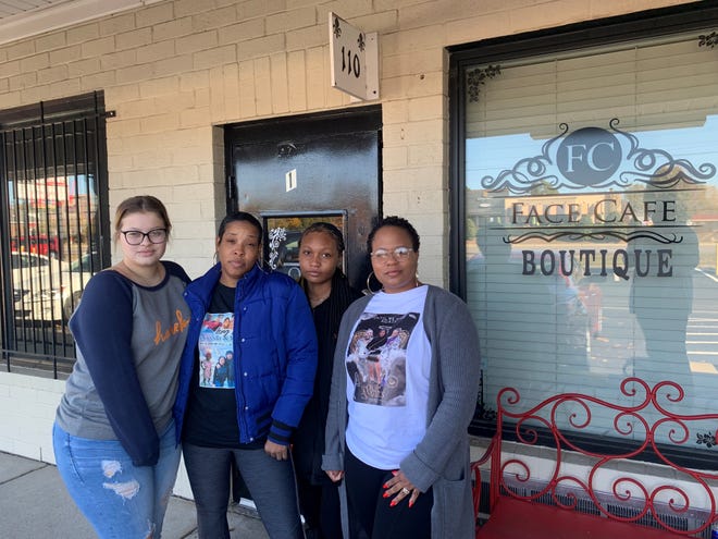 From left, Konye Melvin's girlfriend Laycee Maynard, his mom Tiana Melvin, his cousin Camille Sanders and his aunt Alicia Sanders pose outside Face Cafe Boutique on Ramsey Street, owned by their relative Charlise Curtis.