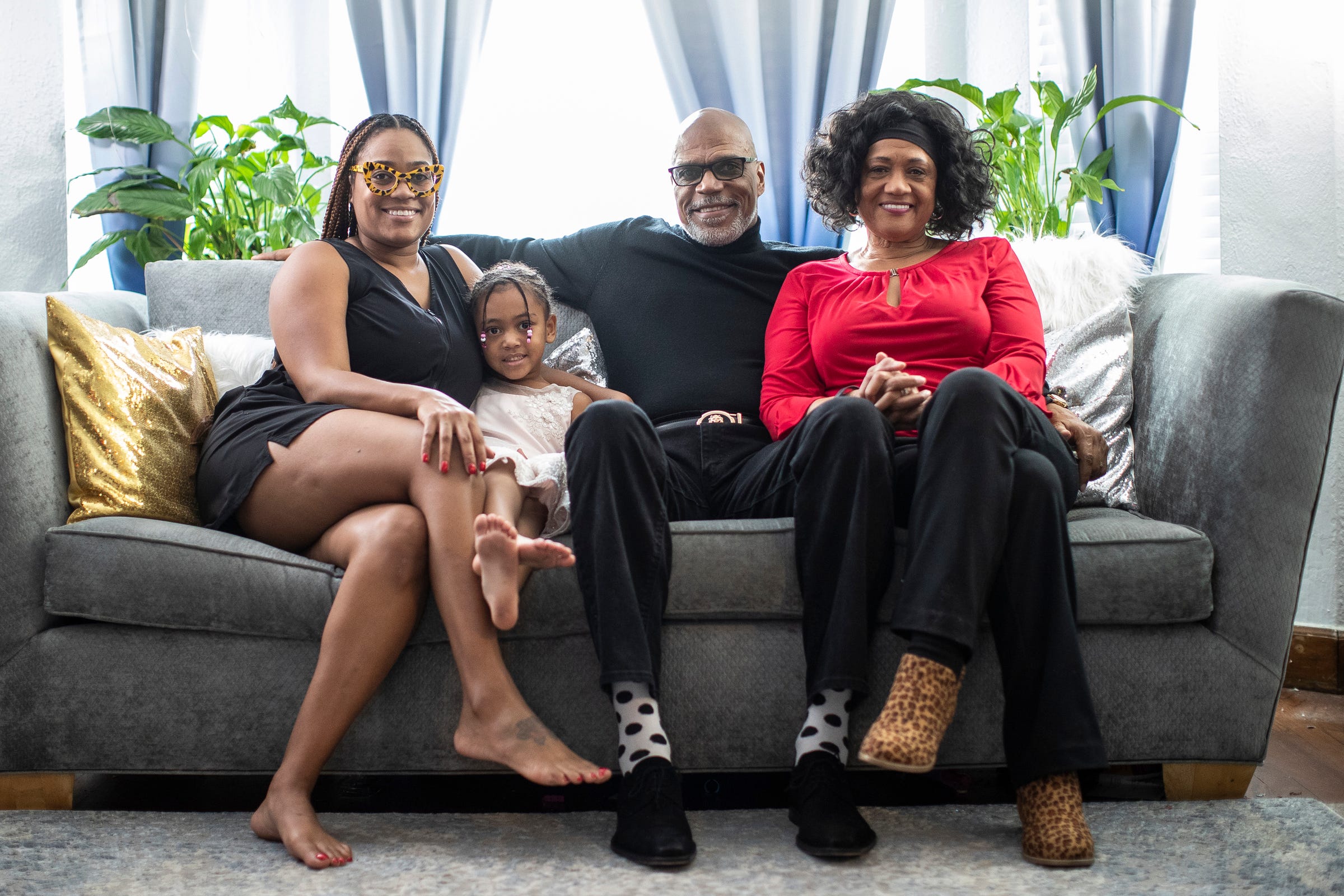From left, Randy Henry's daughter Rachel Henry, granddaughter Simone McCants, 4, himself and his wife Carmen Henry at their home in Detroit on Nov. 24, 2021.