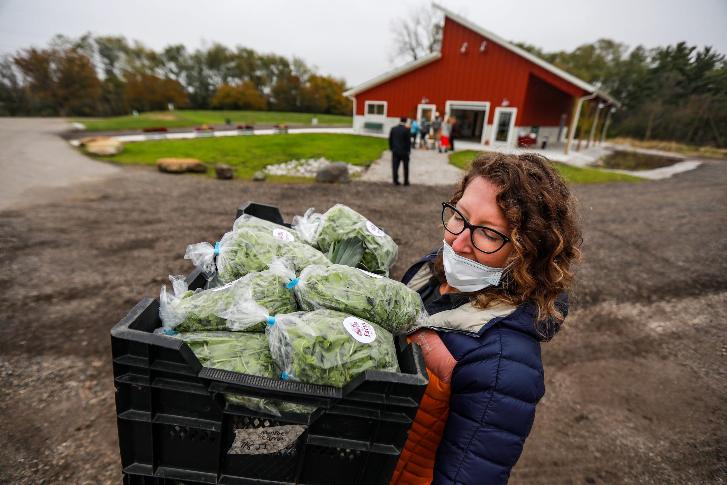 The Farm Program Manager Liz Tylander, moves crates of fresh produce from the Farm at Saint Joseph Mercy Health System to deliver to the hospital for the Patients-to-Produce program in Ann Arbor on Oct. 27, 2021. In 2020, The Farm donated more than 6,300 pounds of produce to 3,600 health care providers and 1,300 patients. In addition, the Ann Arbor farm distributed 11,500 boxes of Michigan produce to members of the community, including 83 food-insecure families.