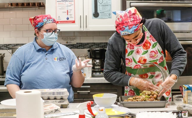 Indiana Youth Group's Faye Pudlo, left, and Olivia Figueroa help to make a holiday meal for the annual Youth Harvest Celebration on Wed. Nov. 24, 2021, at the Indiana Youth Group building on Meridian St. in Indianapolis. 