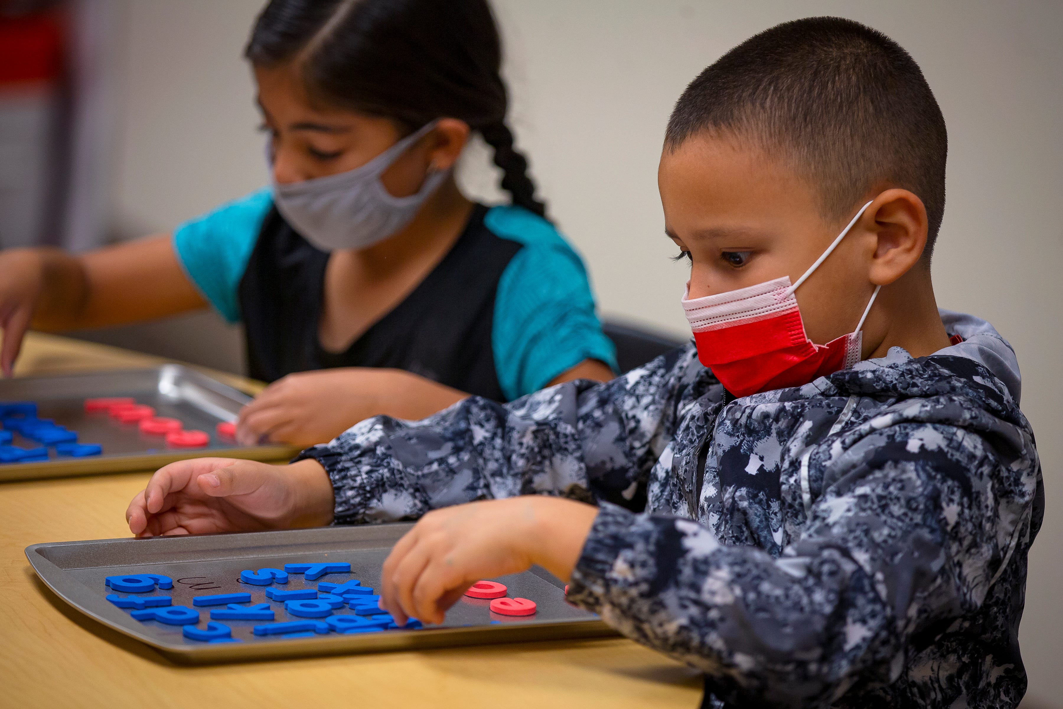 First-grade students participate in a phonics activity with magnetic letters during an intensive reading class at Freedom Elementary School in Buckeye, Arizona, on Nov. 16, 2021.