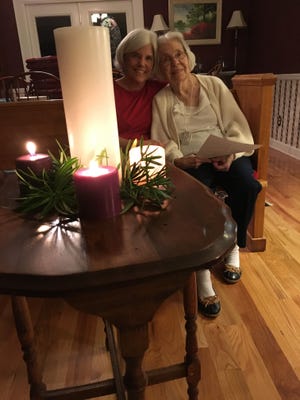 Candace and her mother light the Christ Candle on Christmas eve in 2017.