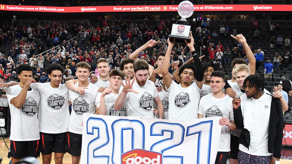 The Gonzaga Bulldogs players celebrate with the Good Sam Empire Classic championship trophy after defeating the UCLA Bruins 83-63 at T-Mobile Arena.