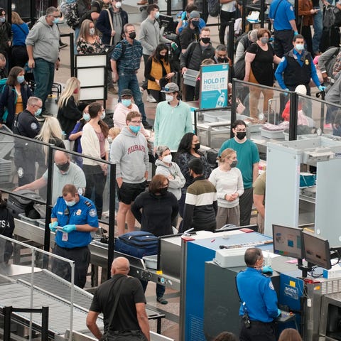 Travellers check in queue up at the south security