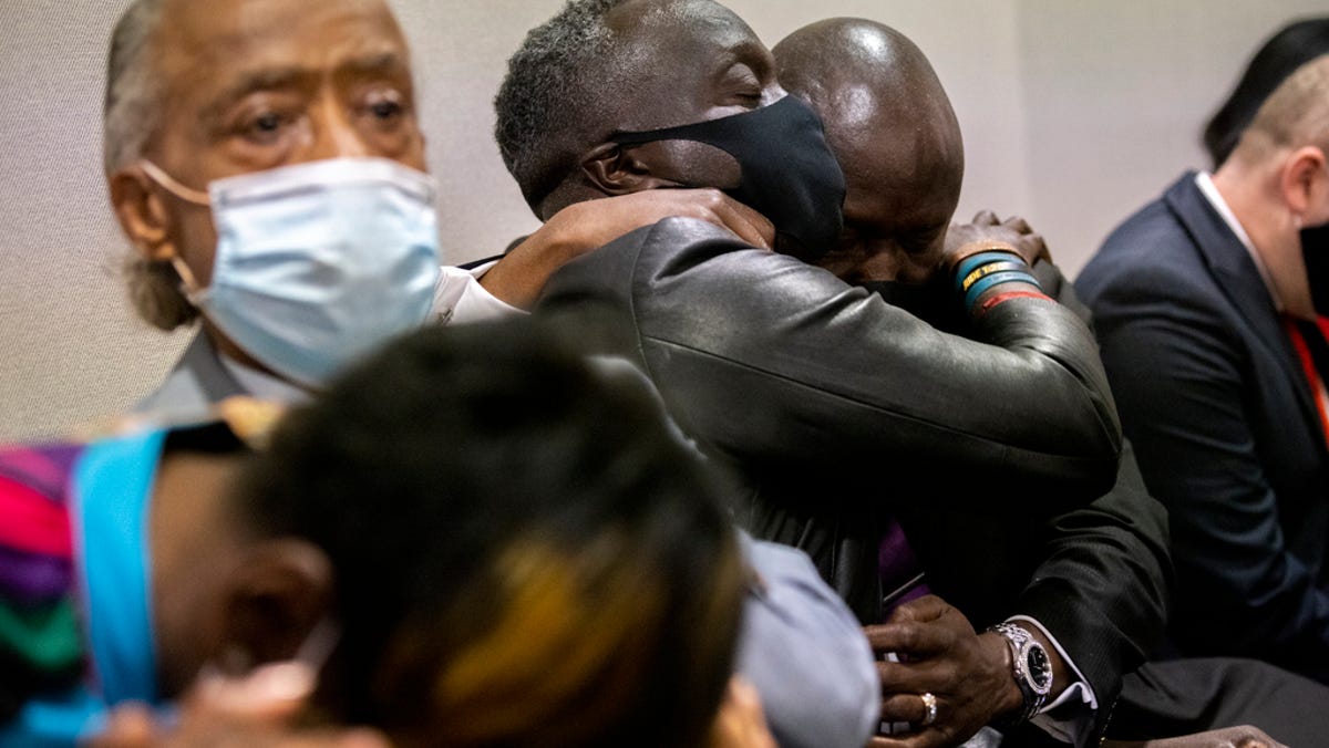 Ahmaud Arbery's father Marcus Arbery, center, his hugged by his attorney Benjamin Crump after the jury convicted Travis McMichael in the Glynn County Courthouse, Wednesday, Nov. 24, 2021, in Brunswick, Ga.  Greg McMichael and his son, Travis McMichael, and a neighbor, William "Roddie" Bryan, charged in the death of Ahmaud Arbery were convicted of murder Wednesday in the fatal shooting that became part of a larger national reckoning on   racial injustice.