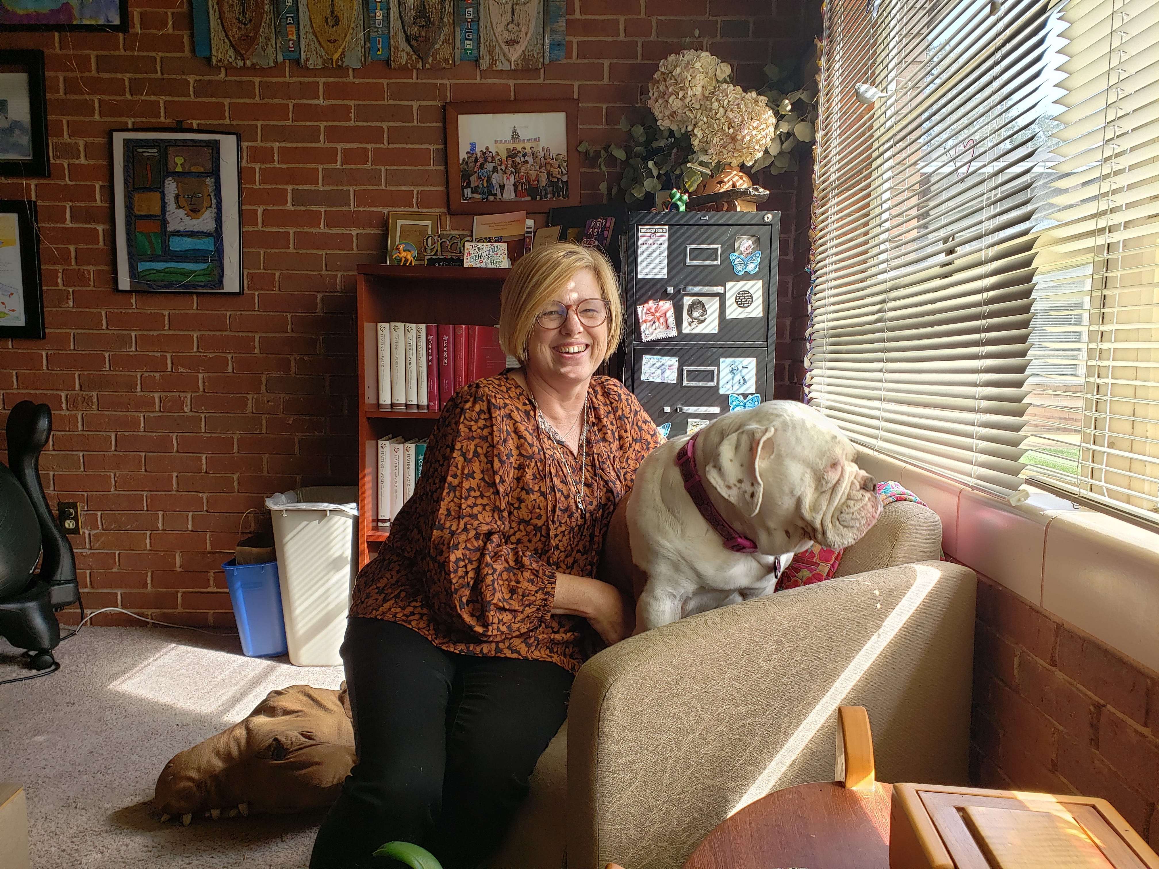 The Rev. Cathy Caldwell Hoop, and her ever-present friend Lily, in Hoop's office at Grace Presbyterian Church.