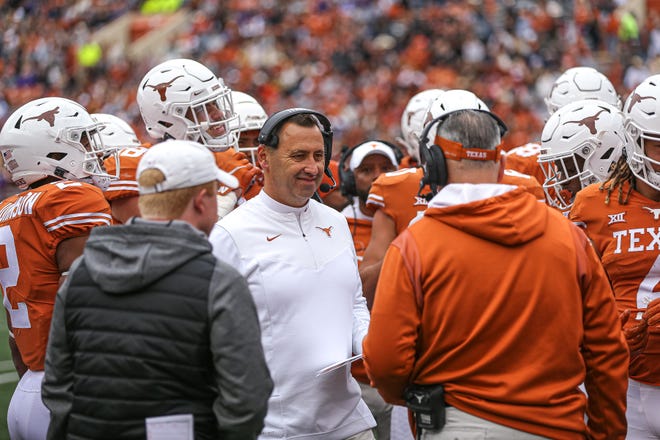 Texas head coach Steve Sarkisian smiles while talking to other coaches during the Texas game against Kansas State at Royal-Memorial Stadium on Nov. 26. Texas defeated Kansas State 22-17. The Longhorns landed five-star offensive lineman Kelvin Banks on Saturday.