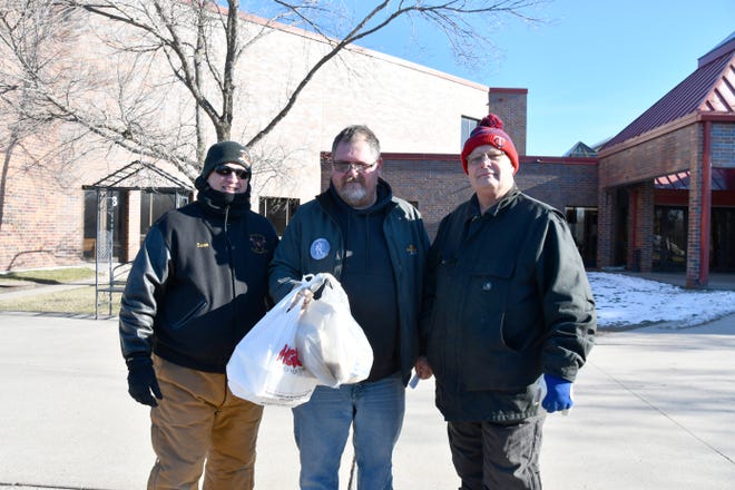 Mike Swenson, Chris Bushy and Lester Wilkens helped serve free Thanksgiving meals at Cathedral Church Thursday. 302 meals were served during the annual event.