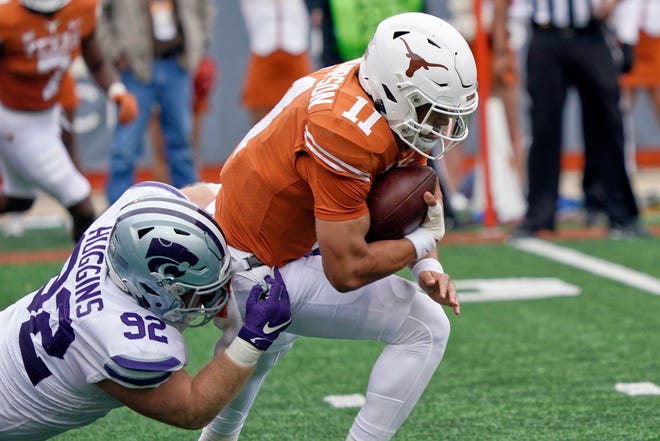 Texas quarterback Casey Thompson (11) is sacked by Kansas State defensive tackle Eli Huggins (92) during the Friday's game in Austin, Texas.