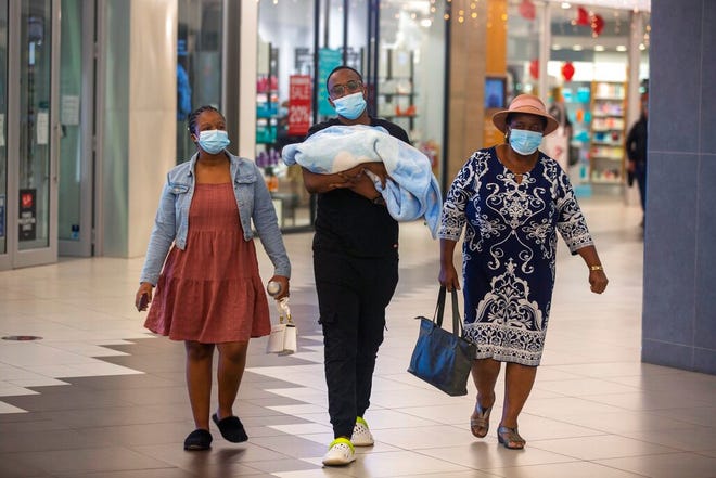 People with masks walik, at a shopping mall, in Johannesburg, South Africa, Friday Nov. 26, 2021. Advisers to the World Health Organization are holding a special session Friday to flesh out information about a worrying new variant of the coronavirus that has emerged in South Africa, though its impact on COVID-19 vaccines may not be known for weeks. (AP Photo/Denis Farrell)